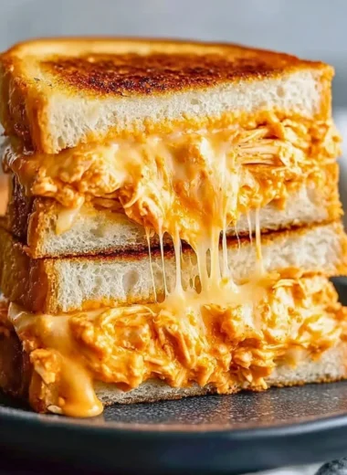 Delicious Buffalo Chicken Grilled Cheese Sandwich with melted cheese and spicy chicken