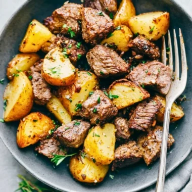 Delicious Garlic Butter Steak Bites with crispy potatoes served on a plate