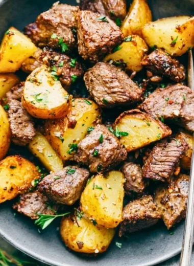 Delicious Garlic Butter Steak Bites with crispy potatoes served on a plate