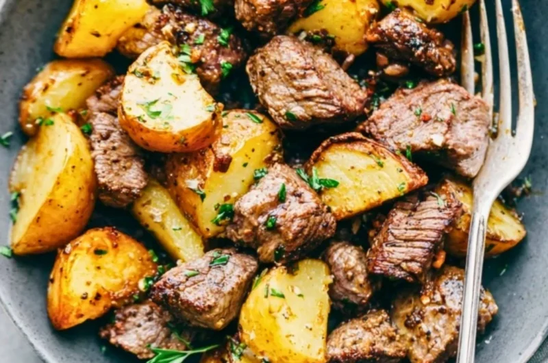 Delicious Garlic Butter Steak Bites with crispy potatoes served on a plate