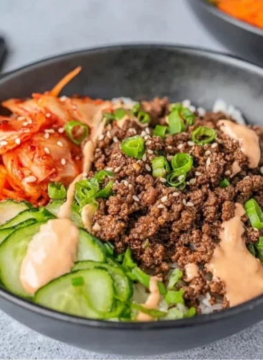 Korean Beef Rice Bowl topped with fresh vegetables and garnished with sesame seeds