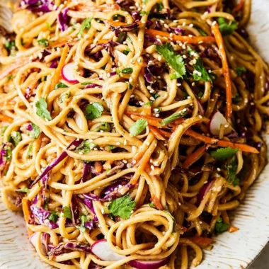 Asian Noodle Salad with colorful vegetables in a rich peanut dressing