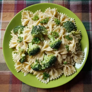 Creamy Broccoli Alfredo Pasta topped with parmesan cheese and fresh herbs