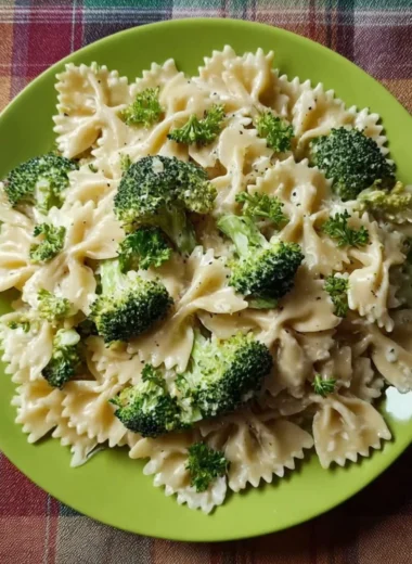 Creamy Broccoli Alfredo Pasta topped with parmesan cheese and fresh herbs