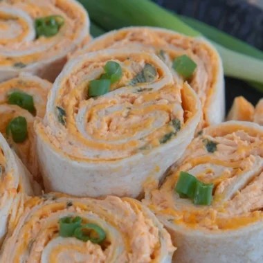 Buffalo Chicken Pinwheels served on a platter with fresh veggies