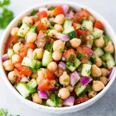 Delicious chickpea salad garnished with fresh vegetables and herbs