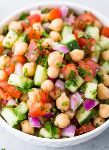 Delicious chickpea salad garnished with fresh vegetables and herbs