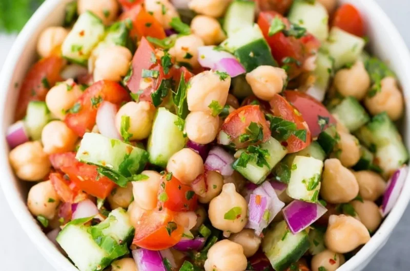 Delicious chickpea salad garnished with fresh vegetables and herbs