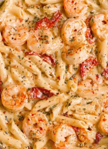 Delicious creamy shrimp pasta garnished with herbs in a bowl