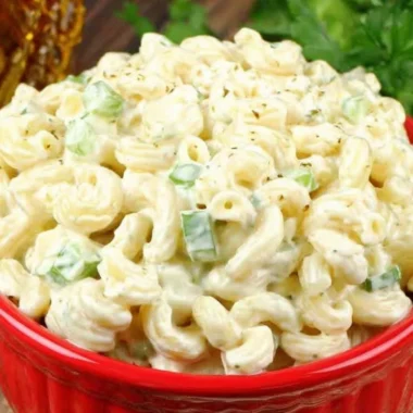 Deli-style macaroni salad with vegetables and dressing in a bowl
