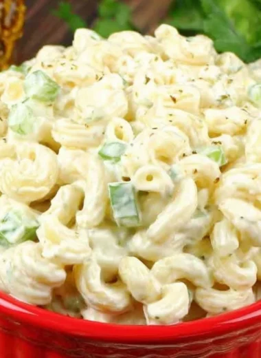 Deli-style macaroni salad with vegetables and dressing in a bowl