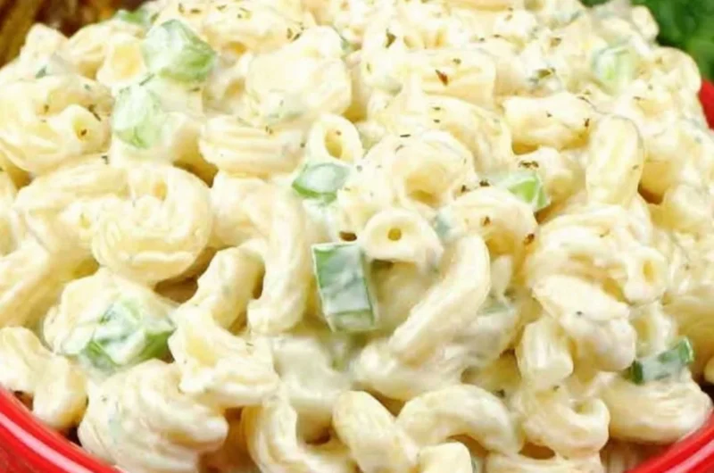 Deli-style macaroni salad with vegetables and dressing in a bowl