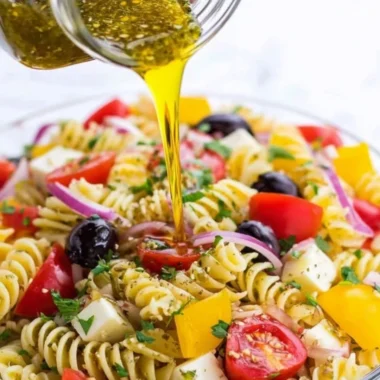 A bowl of homemade Italian dressing with herbs and spices