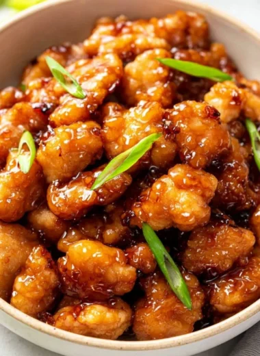 Plate of crispy Honey Butter Chicken drizzled with honey and butter sauce.