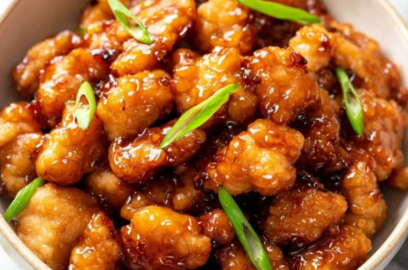 Plate of crispy Honey Butter Chicken drizzled with honey and butter sauce.