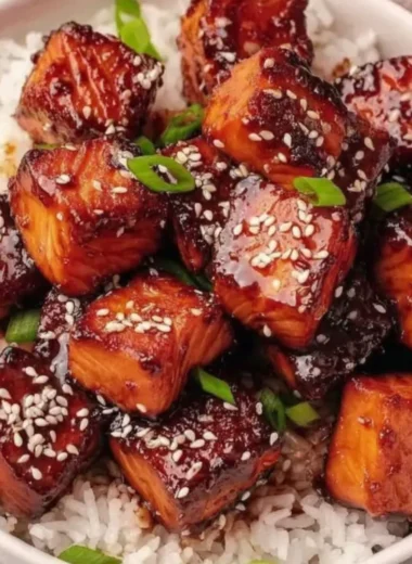 Honey Garlic Salmon Bites Bowl garnished with vegetables and sesame seeds.