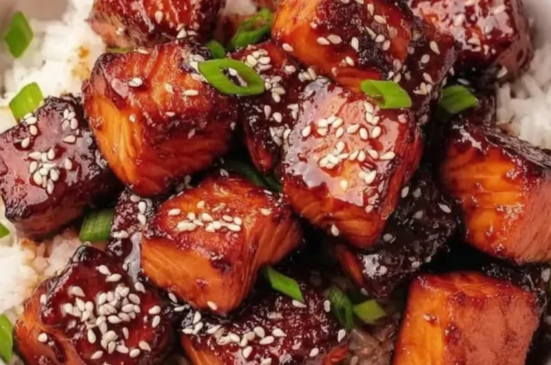 Honey Garlic Salmon Bites Bowl garnished with vegetables and sesame seeds.