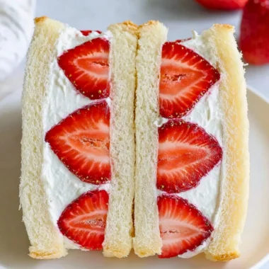 Japanese strawberry sandwich featuring fresh strawberries and cream between soft bread.