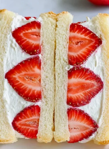 Japanese strawberry sandwich featuring fresh strawberries and cream between soft bread.