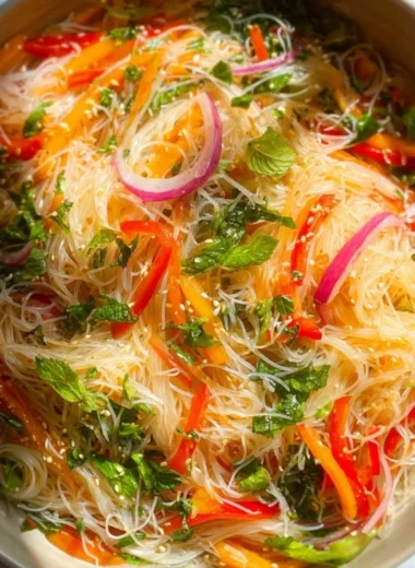 A vibrant no cook noodle salad in a bowl with colorful vegetables.