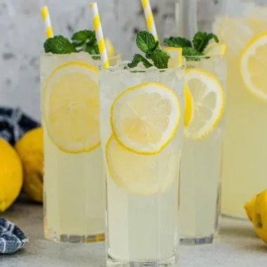 Refreshing old-fashioned homemade lemonade in a glass with lemon slices