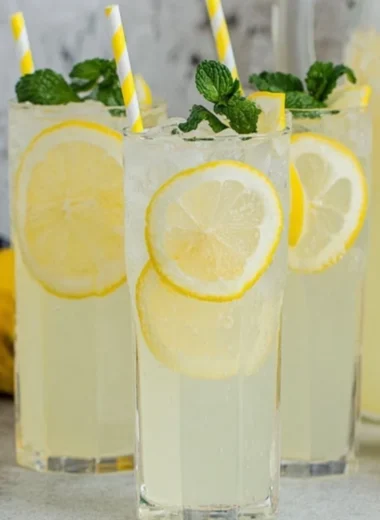 Refreshing old-fashioned homemade lemonade in a glass with lemon slices