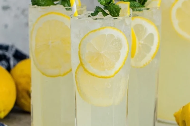 Refreshing old-fashioned homemade lemonade in a glass with lemon slices