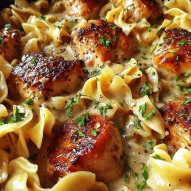 One-Pan Creamy Garlic Butter Chicken served with egg noodles in a skillet