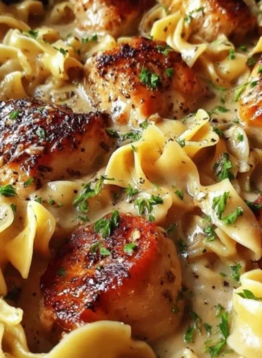 One-Pan Creamy Garlic Butter Chicken served with egg noodles in a skillet
