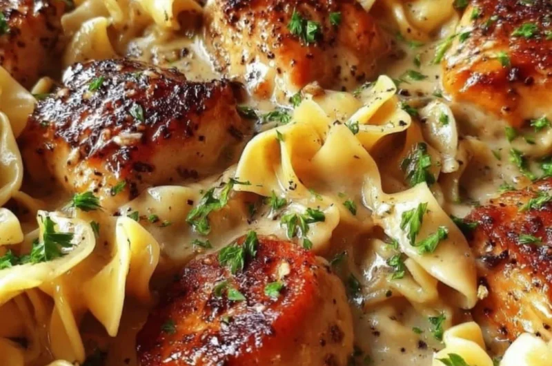 One-Pan Creamy Garlic Butter Chicken served with egg noodles in a skillet