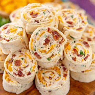 Colorful potluck pinwheels served on a platter at a gathering.