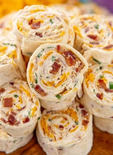 Colorful potluck pinwheels served on a platter at a gathering.