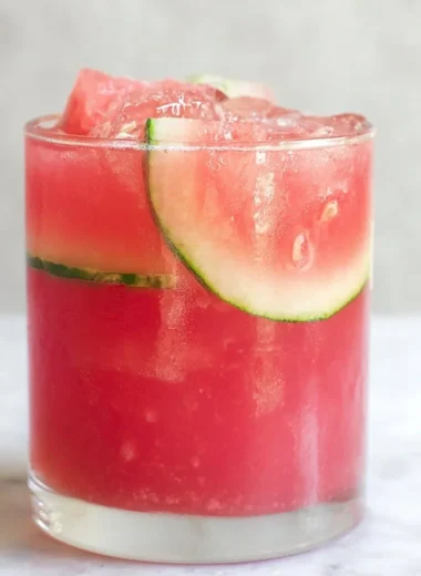 Refreshing watermelon cocktail punch served in a glass with mint and ice