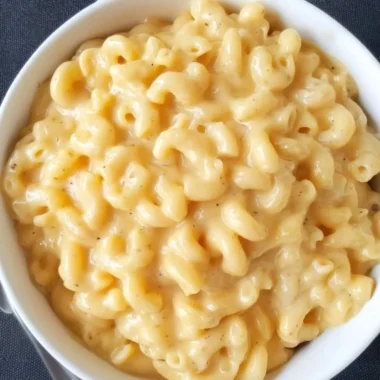 Simple homemade Mac and Cheese served in a bowl with cheese topping.
