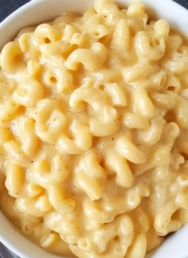 Simple homemade Mac and Cheese served in a bowl with cheese topping.