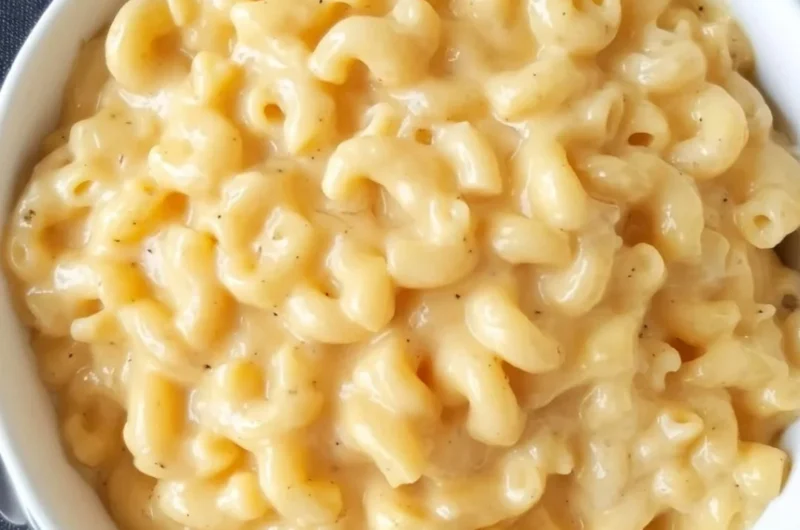 Simple homemade Mac and Cheese served in a bowl with cheese topping.