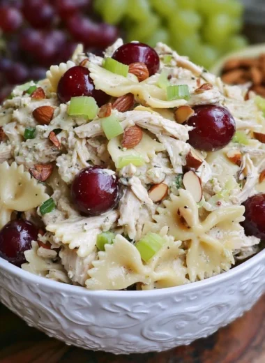 Waldorf Chicken Salad with pasta, apples, walnuts, and celery in a bowl