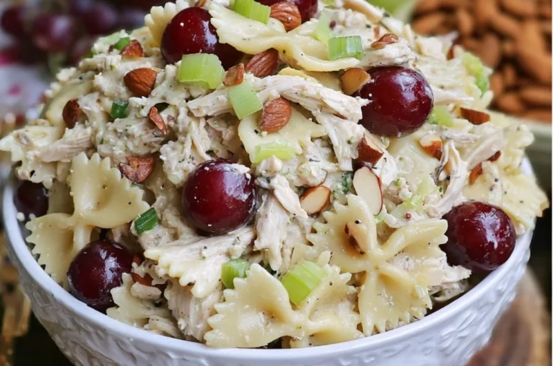 Waldorf Chicken Salad with pasta, apples, walnuts, and celery in a bowl