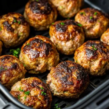 Crispy air fryer meatballs served with dipping sauce on a plate