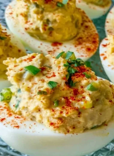 Plate of Cajun Deviled Eggs garnished with spices and herbs