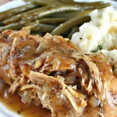 Crock Pot Mississippi Chicken served with herbs and spices for a flavorful meal.