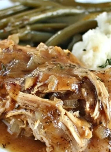 Crock Pot Mississippi Chicken served with herbs and spices for a flavorful meal.