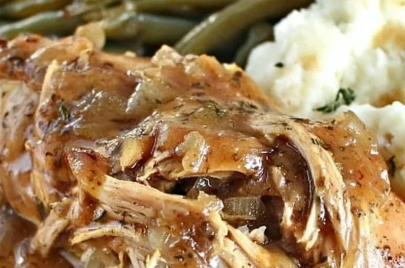 Crock Pot Mississippi Chicken served with herbs and spices for a flavorful meal.