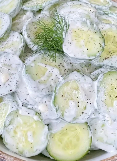 Refreshing cucumber salad with mayo and sour cream in a bowl