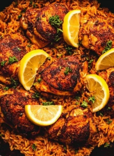 One pan Spanish chicken and rice dish garnished with fresh herbs