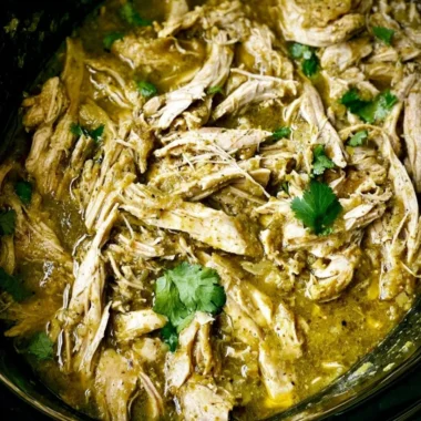 Delicious Green Sauce Crockpot Chicken served with fresh herbs