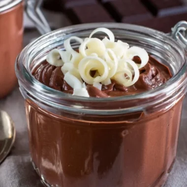 Bowl of creamy homemade chocolate pudding garnished with chocolate shavings