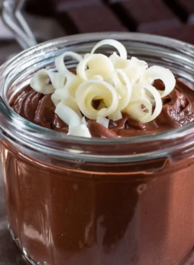 Bowl of creamy homemade chocolate pudding garnished with chocolate shavings