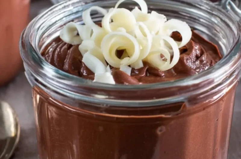Bowl of creamy homemade chocolate pudding garnished with chocolate shavings