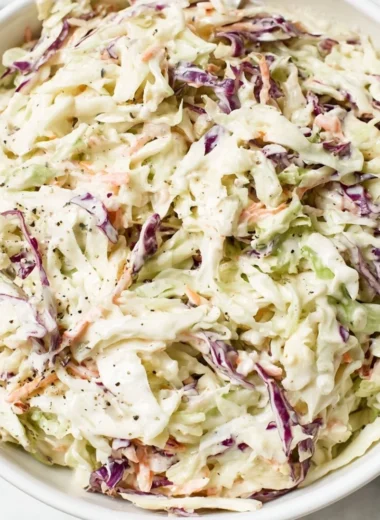 Bowl of perfectly balanced coleslaw with vibrant cabbage and carrots